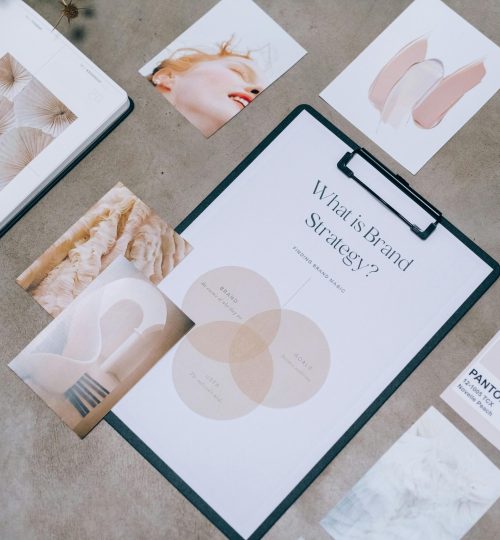 Flat lay showing branding materials and design concepts for creative strategy discussions.